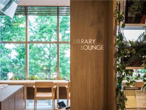 a room with a library lounge sign on a wall at Hotel Wing International Hakata Shinkansenguchi in Fukuoka