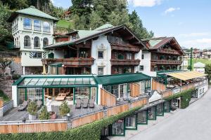 a large building with a balcony in front of it at Wohlfühlhotel KERSCHDORFER - B&B - ADULTS ONLY in Kaltenbach