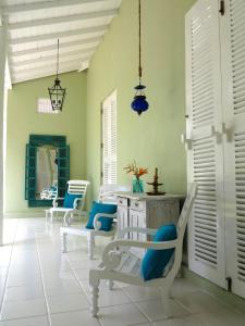 a room with chairs and a table and a mirror at Bungalow Sud in Habaraduwa Central