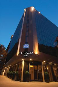 a tall building with a sign on it at Rosslyn Thracia Hotel Sofia in Sofia