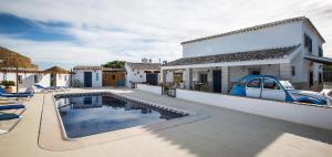 a house with a swimming pool and a car on the roof at B&B Casa Luna Vélez Blanco in Vélez Blanco