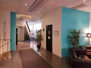 a lobby with couches and plants in a building at Hotell Centralstation in Uppsala