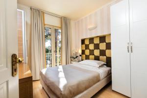 Voodi või voodid majutusasutuse JR Resort Logos Forte dei Marmi toas