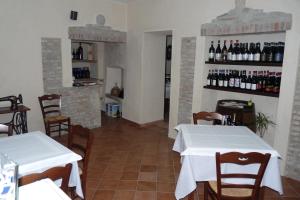 a restaurant with two tables and bottles of wine at Agriturismo Maria Cristina in Treiso