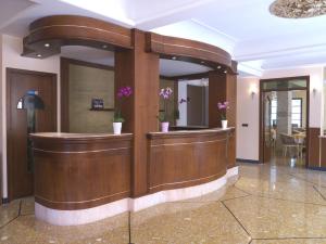 a lobby with a reception desk in a building at Hotel Flora in Celle Ligure