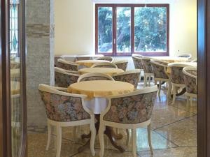 a row of tables and chairs in a room at Hotel Flora in Celle Ligure