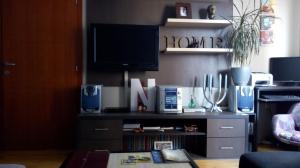 a living room with a tv on top of a table at Naissa Apartment in Niš