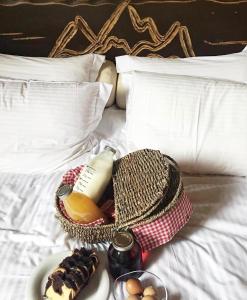 a breakfast tray with a basket of food on a bed at Monte Bianco Villas in Arachova