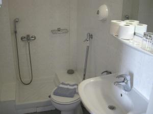 a bathroom with a shower and a toilet and a sink at Oceanis in Thessaloniki