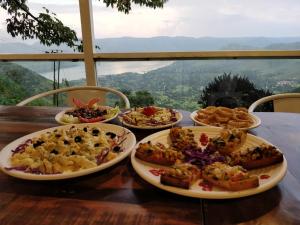 a table with several plates of food on it at Miraya Hotel in Panchgani