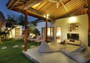 水明漾‎的住宿－Villa Thiara by Optimum Bali Villas，客厅设有带平面电视的庭院。