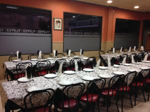 a set of tables and chairs in a room at Pensión Flipper in Bullas