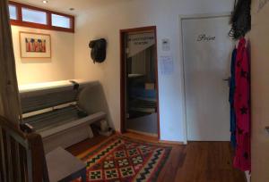 a room with a hallway with a bench and a mirror at B & B Nomad in 't Zand
