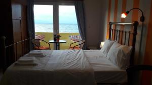 a bedroom with a bed with a view of the ocean at Orange Fodele in Fodele