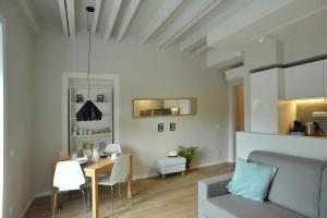 a living room with a table and a couch at Belle Cinque Terre Apartments in La Spezia