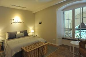 a bedroom with a bed and a large window at Belle Cinque Terre Apartments in La Spezia
