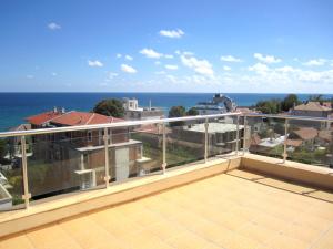 a balcony with a view of the ocean at Hotel COOP Central in Obzor