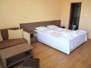 Un pat sau paturi într-o cameră la Hotel COOP Central