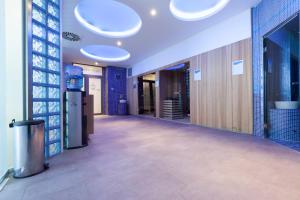 a hallway of an office with blue walls and lights at Hotel Premier Aqua - Adults Only in Vrdnik