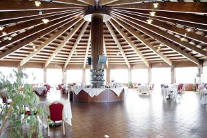 a large room with tables and chairs in a building at Hotel Villa Peretti in Gela