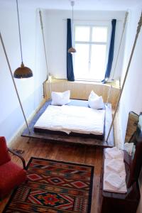a swing bed in a room with a window at Spirit Lodge Leipzig in Leipzig +28 photos