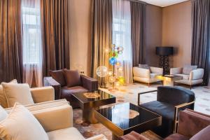 a living room with couches and chairs and a table at The ONE Hotel Astana in Astana