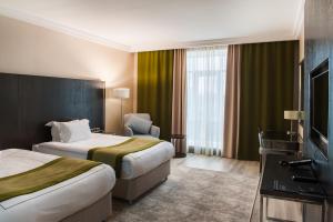 Кровать или кровати в номере The ONE Hotel Astana