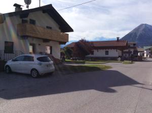 a white car parked in front of a house at Ferienwohnung Philipp in Leutasch