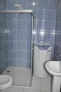 a bathroom with a shower and a toilet and a sink at Itacaré EcoRanch Casa in Itacaré