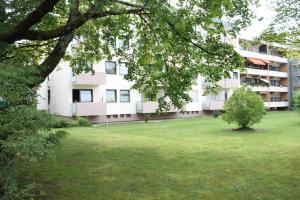 an apartment building with a lawn in front of it at Cosy little apartment in Munich