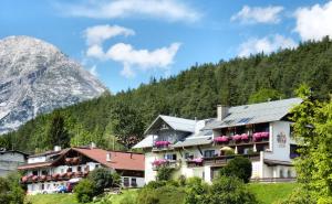 a hotel in the mountains with a mountain at Pension Spiegl in Seefeld in Tirol