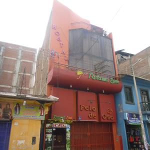 a building with a sign on the side of it at Hostal Retama Inn in Huancayo