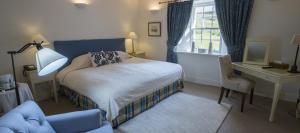 a bedroom with a bed and a desk with a computer at Bridgend Hotel in Bridgend