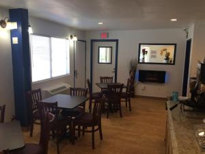 a dining room with tables and chairs and a fireplace at Travelodge by Wyndham Raton in Raton