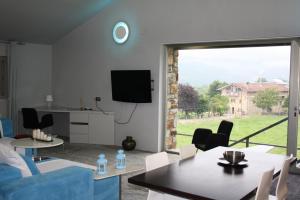 a living room with a blue couch and a large window at Habitaciones amplias tipo Suite Durango in Guyuria