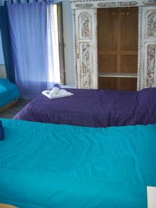 Una cama o camas en una habitación de Hosteria Aura Azul (ex Ser Azul)