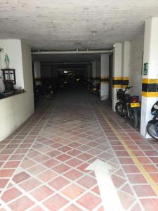 a parking garage with motorcycles parked in it at Hotel Casa del Abuelo in Popayan