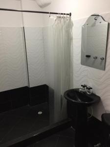 a bathroom with a sink and a shower at Hotel Casa del Abuelo in Popayan
