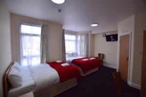 Giường trong phòng chung tại Woodlands Lodge Ilford