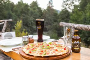 a pizza on a table with two bottles of beer at Huilo Huilo Canopy Village in Huilo Huilo