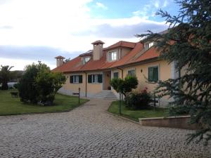 a house with a brick driveway in front of it at Casa Vale de Azibo in Macedo de Cavaleiros