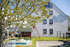 a building with a playground in front of a building at Haus Isabel in Büsum