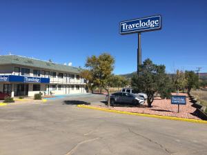 a car parked in a parking lot in front of a hotel at Travelodge by Wyndham Raton in Raton