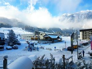 a group of people skiing on a snow covered mountain at Rock Noir & Spa in La Salle-les-Alpes
