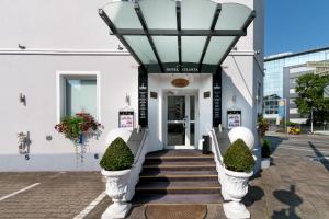 a lobby of a building with stairs leading to a door at HOTEL ATLANTA Darmstadt SUPERIOR in Darmstadt
