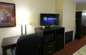 a hotel room with a desk with a television and a chair at Baymont by Wyndham Sevierville Pigeon Forge in Sevierville
