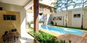 a swimming pool in the backyard of a house at Ecos Conforto in Porto Velho