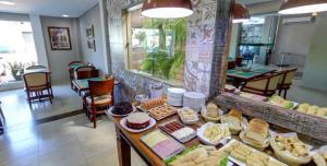 a bakery with a table filled with different types of food at Ecos Conforto in Porto Velho