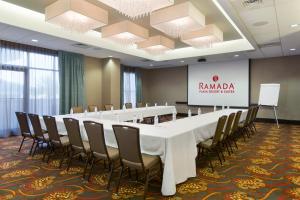 a conference room with a long table and chairs at Plaza Suites On International Drive Near Universal Studios in Orlando