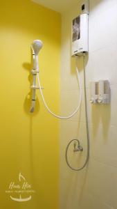 a shower in a bathroom with a shower head at HuaHin Night Market Hostel in Hua Hin
